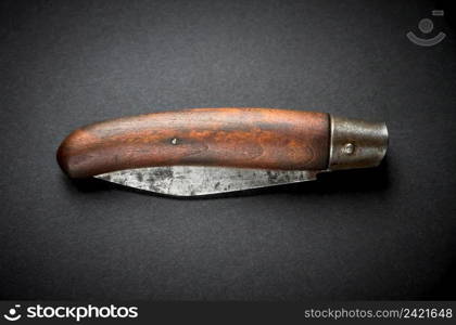 Traditional wooden pocket knife on a black background. Traditional wooden pocket knife on black background