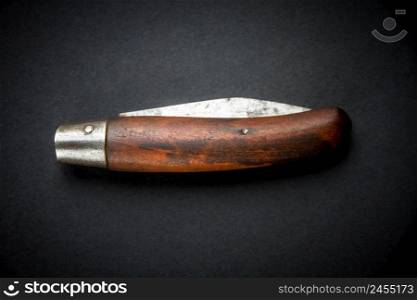 Traditional wooden pocket knife on a black background. Traditional wooden pocket knife on black background