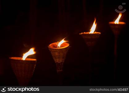 Traditional wooden torch flame at night
