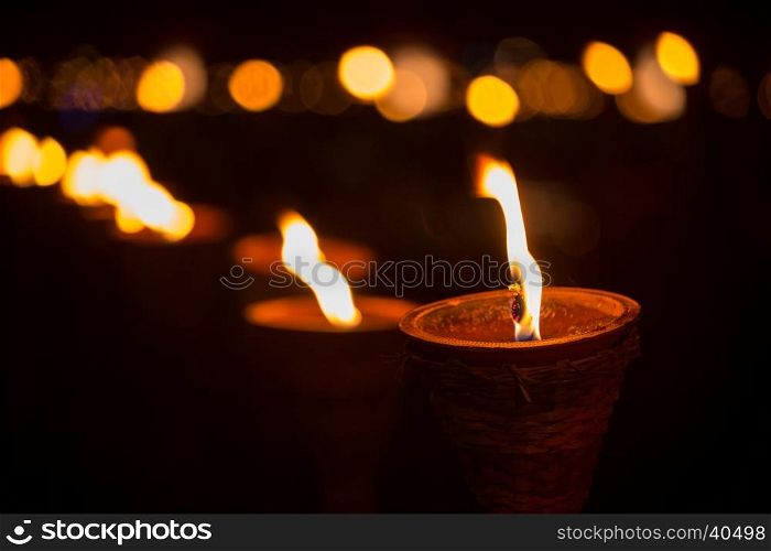 Traditional wooden torch flame with bokeh at night