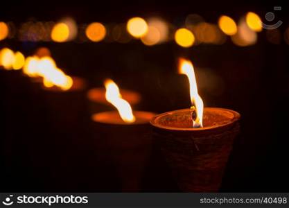 Traditional wooden torch flame with bokeh at night