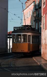 Traditional yellow tram at old street, Lisbon old city, Portugal