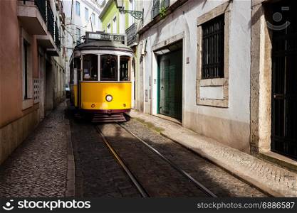 Traditional yellow tram at old streets, Lisbon old city, Portugal