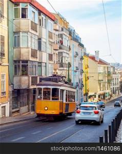 Traditional yellow tram in Lisbon downtown street, sunny weather, Portugal