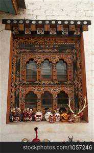 Traditionally decorated window and wooden masks at Thimpu, Bhutan. Traditionally decorated window and wooden masks, Thimpu, Bhutan