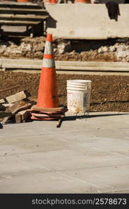 Traffic cone with a bucket at a construction site