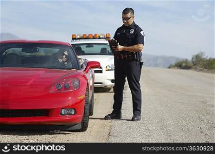 Traffic cop standing by sports car