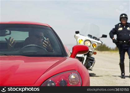 Traffic cop stopping sports car