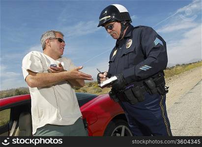 Traffic cop talking with driver of sports car