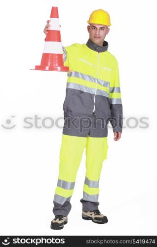 Traffic guard holding a pylon