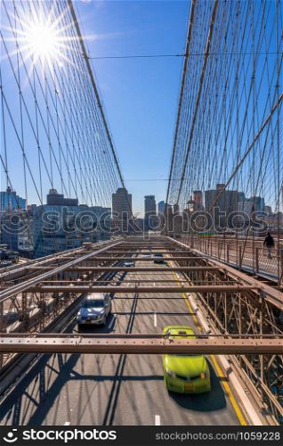 Traffic in morning rush hour before working day on the Brooklyn bridge over New York cityscape background, USA, United States, Business and transportation concept