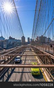 Traffic in morning rush hour before working day on the Brooklyn bridge over New York cityscape background, USA, United States, Business and transportation concept