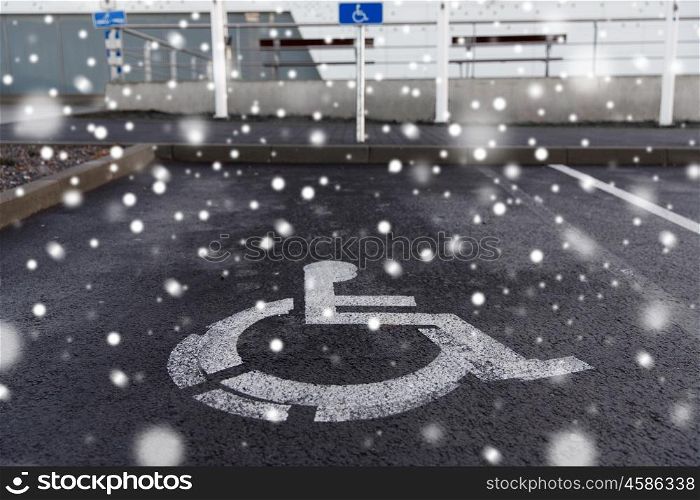 traffic laws and highway code concept - car parking road sign for disabled outdoors over snow. car parking road sign for disabled outdoors