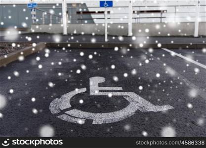 traffic laws and highway code concept - car parking road sign for disabled outdoors over snow. car parking road sign for disabled outdoors