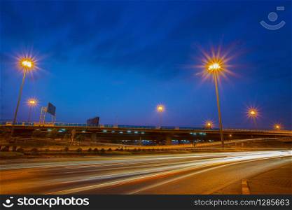 traffic light and urban road against dusky blue sky