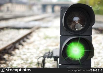 Traffic light shows red signal on railway. Green light
