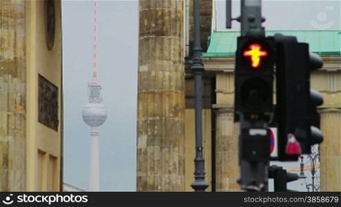 Traffic lights in front of Brandenburg gate with TV tower in distance