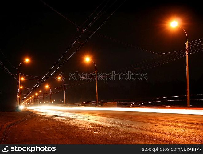 traffic ob night road with street lamps in fog