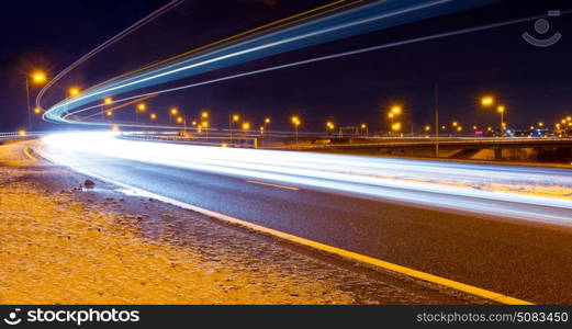Traffic on a motorway viaduct on a winter night