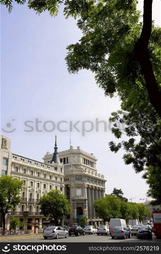 Traffic on a road in front of a building, Madrid, Spain