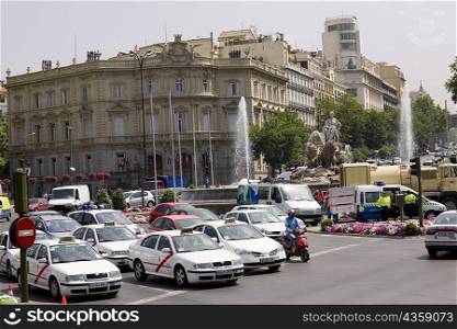 Traffic on a road in front of a palace, Cibeles Fountain, Palacio de Linares, Plaza de Cibeles, Madrid, Spain