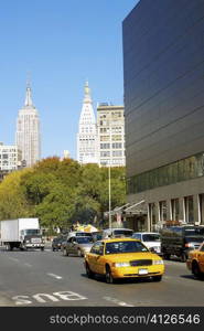 Traffic on a road with skyscrapers in the background, Empire State Building, Manhattan, New York City, New York State, USA