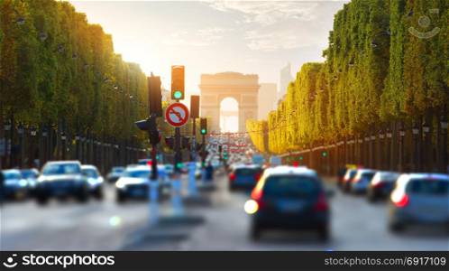 Traffic on Champs Elysee and view of Arc de Triomphe in Paris, France