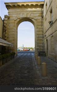 Traffic on road viewed through an arch, Porte de la Monnaie, Vieux Bordeaux, Bordeaux, France
