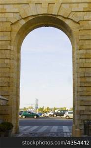 Traffic on road viewed through an arch, Porte de la Monnaie, Vieux Bordeaux, Bordeaux, France