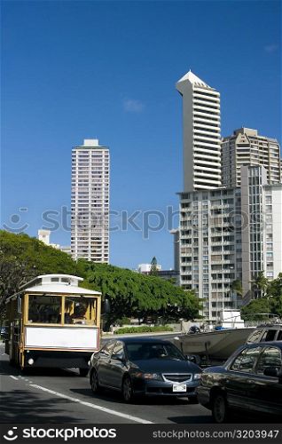 Traffic on the road with skyscrapers in the background, Honolulu, Oahu, Hawaii Islands, USA