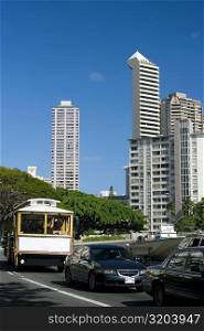 Traffic on the road with skyscrapers in the background, Honolulu, Oahu, Hawaii Islands, USA