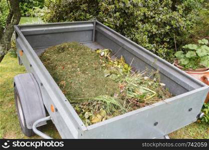 Trailer full of garden waste after cleaning a garden during spring