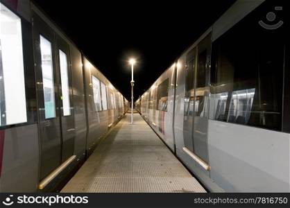 Train cars at a subway depot at night