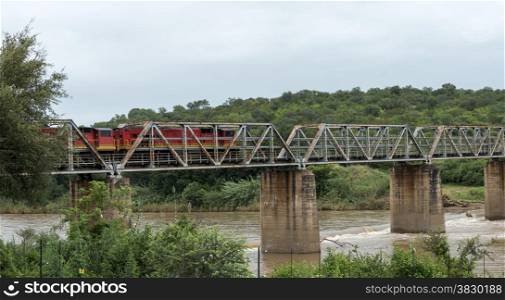 train crossing bridge over elephant riverin south africa near the palce hoedspruit