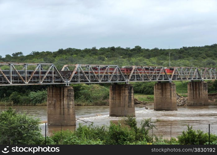 train crossing bridge over elephant riverin south africa near the palce hoedspruit