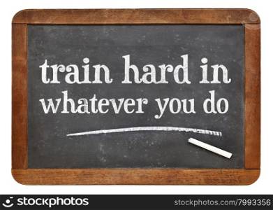 Train hard in whatever you do - advice in white chalk on a vintage slate blackboard
