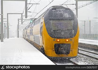 Train in snowstorm departing from Bijlmer station in Amsterdam Netherlands