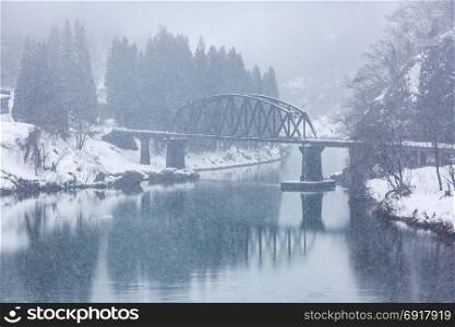 Train in Winter landscape snow on bridge