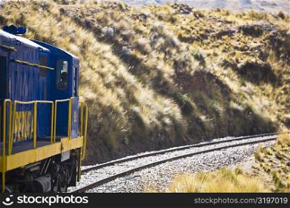 Train passing through a landscape, Puno, Cuzco, Peru