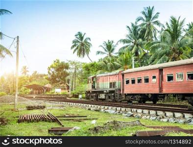 Train station and old locomotive, railway road of Sri Lanka. Ceylon tropical landscape