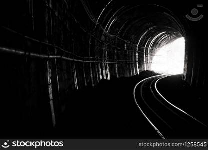Train tunnel. Old railway in cave. Hope of life in the end of the way. Railroad of locomotive train in Thailand. Old architecture. Railway tunnel built in 1914. Travel and hope at the destination.