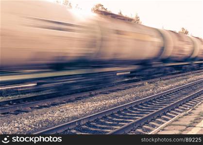Train with oil tanks moving.. Train with oil tanks moving. Transportation of fuel on the railroad. Motion blur.