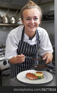 Trainee Chef Working In Restaurant Kitchen