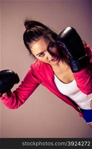 Training, boxing and exercises. Women lifestyle concept. Fit girl with gloves in studio. Retro and vintage photo.
