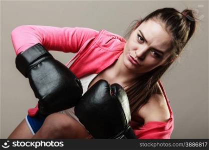 Training, boxing and exercises. Women lifestyle concept. Fit girl with gloves on grey background in studio.