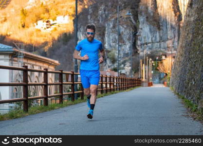 Training for the marathon on a cycle path. A male athlete