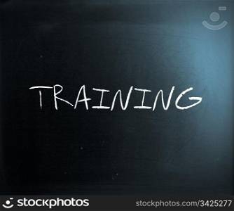 ""Training" handwritten with white chalk on a blackboard."