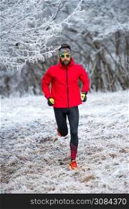 Training of a runner trail in the cold in the frost.