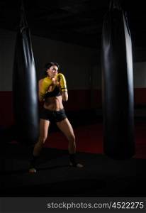 Training of kickboxer woman at gym