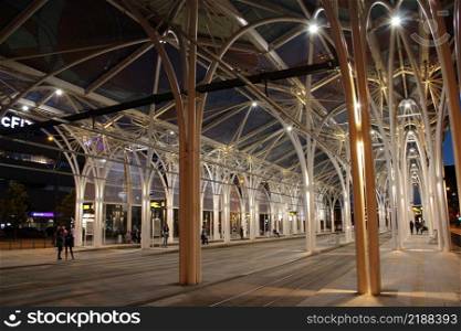Tram depot in Lodz. Building of tram depot with modern architecture. Polish city Lodz. city architecture. Tram depot illuminated in the evening in city of Lodz. Tram depot illuminated in the evening in the city of Lodz